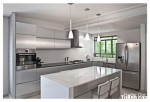 Tủ bếp gỗ Acrylic màu xám bạc chữ L có bàn đảo và hệ khung tủ lạnh – TBT1602